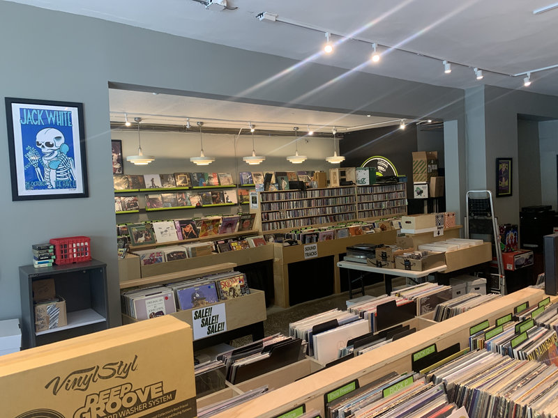 Inside Irving Place Records with rows of vinyl bins and wall displays